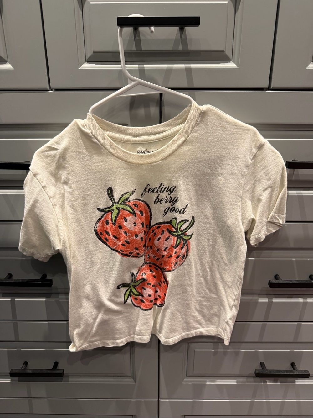 Rebellious One Cream Tee with Red Strawberry Graphic